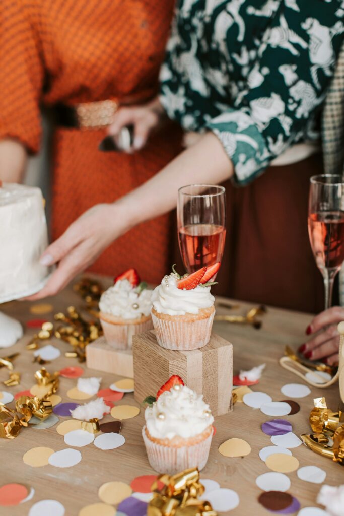 Lively party scene with cupcakes, champagne, and colorful confetti.
